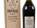 a bottle of wine sitting next to a wooden box