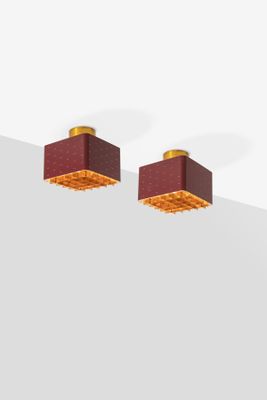 pair of red and gold square stud earrings on a white surface