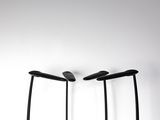 three black lamps that are on a white surface