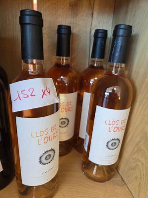 several bottles of wine are lined up on a shelf