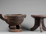 two small wooden bowls and a small wooden bowl on stands