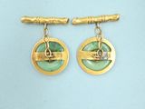 two pairs of gold and green earrings on a blue background