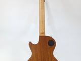 a close up of a guitar on a stand against a white background