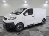 la camionnette blanche est garée sur un sol carrelé en damier