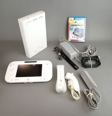 a nintendo wii game system sitting on a table next to a nintendo wii game console