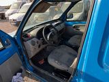 a blue car with the door open sitting in a parking lot