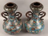 two vases that are sitting side by side on a table