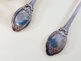 three spoons that are sitting on a table