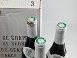 three bottles of wine sitting next to each other on a table