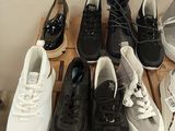 many pairs of shoes that are on a box