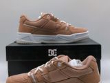 a pair of tan sneakers sitting on top of a box