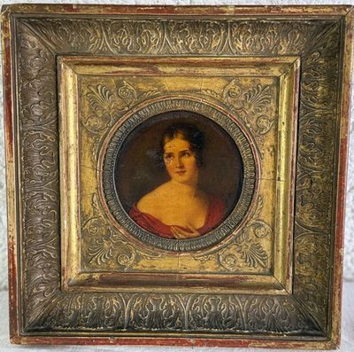 an old picture of a woman in a red dress in a gold frame