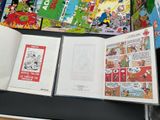 a lot of comic books on the table together
