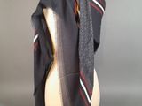 grey scarf with red and white stripes on a mannequin head