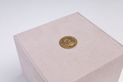 a small box with a gold coin inside of it