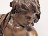 bronze statue of a boy with a book in his hands