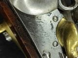 a close up of a gun with a brass handle