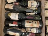 many bottles of wine in a box on the table