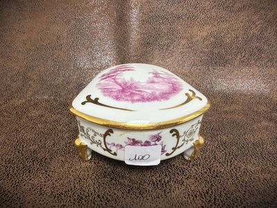 an image of a porcelain box with a flower on it