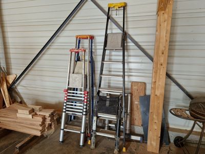 a pile of wood next to a ladder in a garage