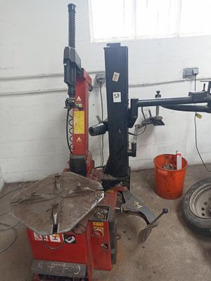 a car being worked on by a mechanic in a garage