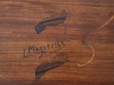 a close up of a piece of wood with writing on it
