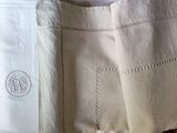 a white bag with a monogram on it sitting on a table
