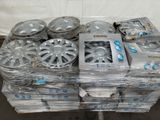 a lot of rims and wheels on a pallet