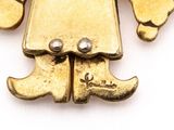 an image of a gold plated robot pendant on a white background