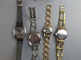 a lot of watches that are sitting on a table