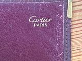 an old purple leather wallet with the word cartier paris written on it