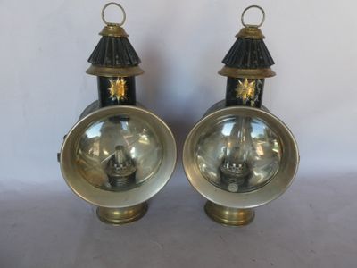 pair of antique brass and black lamps on a white background