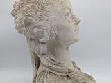 marble bust of a woman ' s head on a white background