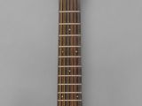 a close up of an acoustic guitar on a gray background