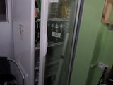 a refrigerator that is sitting in the corner of a room