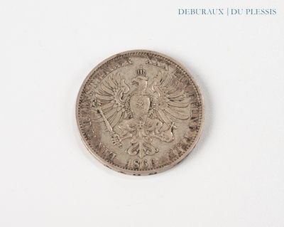 a silver coin on a white surface with a white background