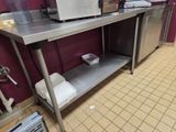 a stainless steel table with a microwave on it