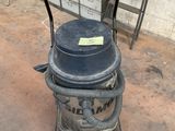 a black and gray vacuum sitting on the ground