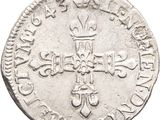 a close up of a coin with a cross on it