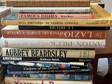 many books stacked on top of each other on a table