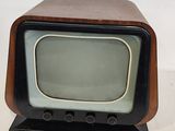 a small television sitting on top of a wooden stand