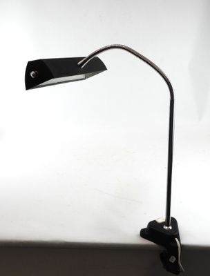 a close up of a desk lamp on a desk with a white background