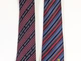 two ties with different colors and patterns on them on a white surface