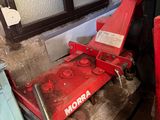 a red machine that is sitting in the corner of a room