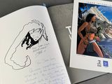 an open book with a drawing of a woman and a picture of a man