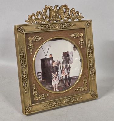 a gold picture frame with a picture of a man and a woman