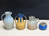 three different vases sitting on a table next to each other
