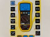a close up of a box with a digital multimeter in it
