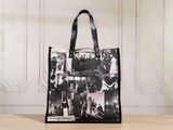 a black and white photo of a tote bag on a table