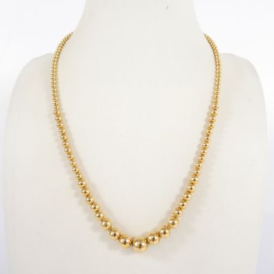 a gold beaded necklace on a mannequin mannequin mannequin mannequin mannequin mannequin mannequin mannequin mann